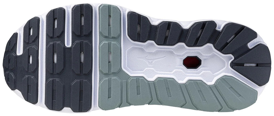 Close-up of a sports shoe outsole with textured grip and multi-tone rubber tread design