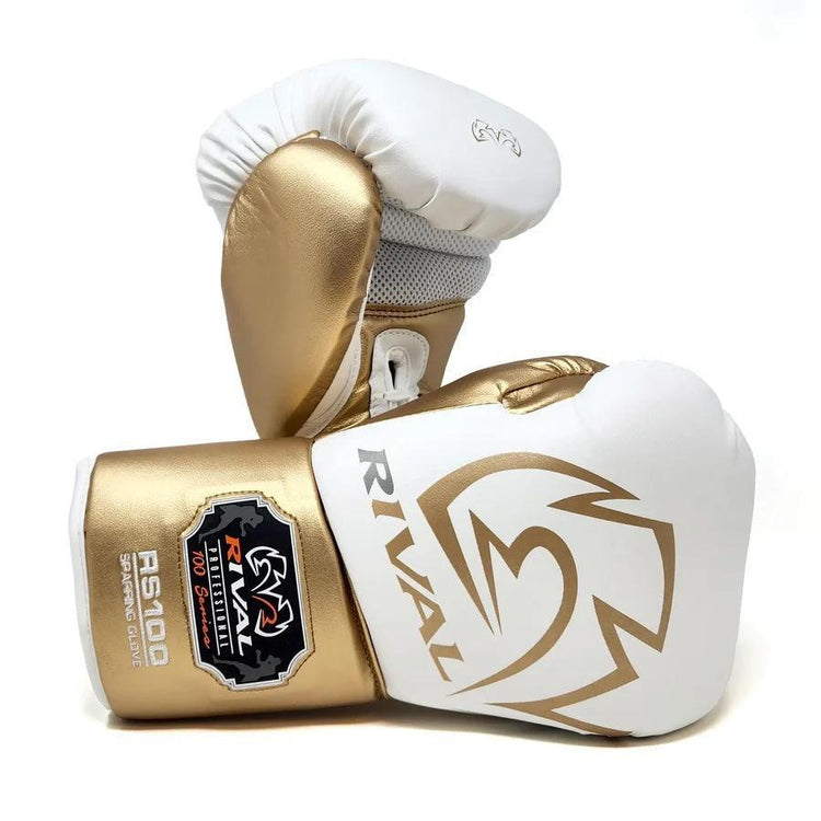 White and gold professional boxing gloves with Rival logo and RS100 label on cuff