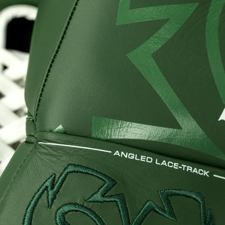 Close-up green boxing glove with angled lace track and bold stitching detail