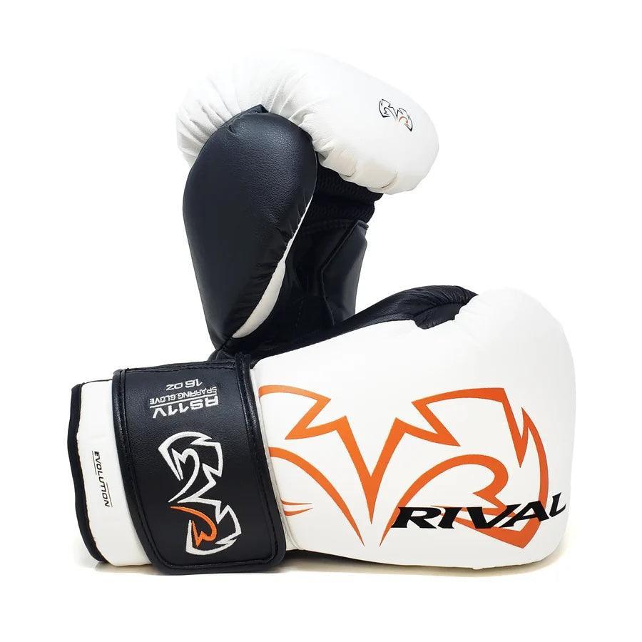 White and black Rival boxing gloves with orange logo, pro-grade sparring gear on white background.